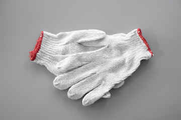 White cloth gloves on gray background.