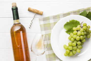 Grapes on plate and white wine