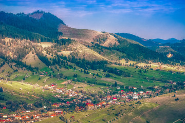 Fototapeta na wymiar Beautiful landscape mountain hill meadow sunrise morning village Bucovina Romania 