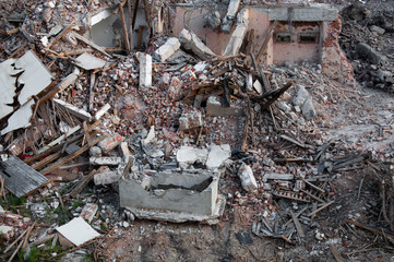 The ruins of the house. Bricks, plaster, boards, iron