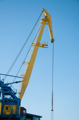 yellow port crane on blue sky background