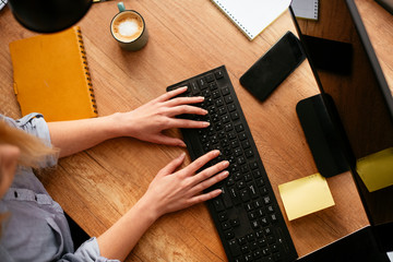 close up of females hand typing on keyboard