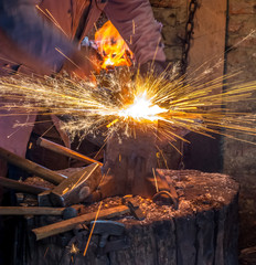 The Blacksmith horse shoe maker fire anvil indoor activity traditional 