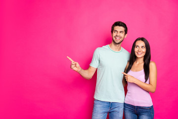 Photo of amazing couple guy and lady indicating fingers to empty space advising black friday...