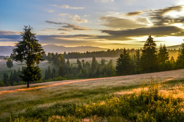 Beautiful landscape mountain hill meadow sunrise morning village Romania 
