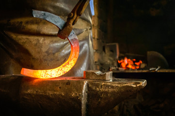 The Blacksmith horse shoe maker fire anvil indoor activity traditional 