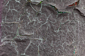 Surface texture with gray paint and cracks on concrete wall. For abstract backgrounds.