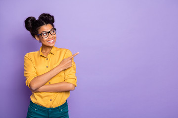 Photo of amazing dark skin lady indicating finger to empty space advising novelty interested...