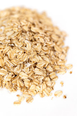 Heap of whole organic oats isolated on white background