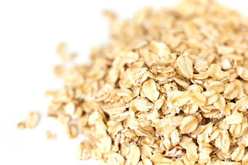 Heap of whole organic oats isolated on white background