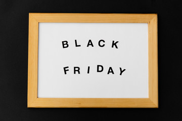 shopping, sale and outlet concept - white magnetic board with black friday words