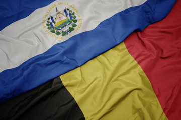 waving colorful flag of belgium and national flag of el salvador.
