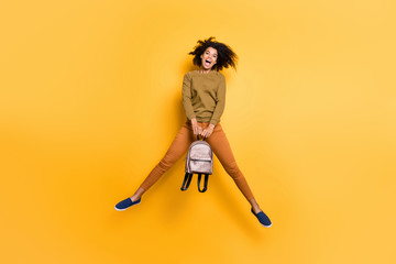 Full length body size photo of cheerful charming positive cute beautiful pretty sweet curly wavy youngster holding handbag with hands jumping with having known about weekend isolated over vivid color