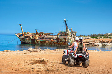 Cyprus. Pathos. White stone. Tourists on ATV arrived to the sunken ship. Shipwrecked off the coast...