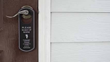 door knob hanging with message note, communication sign message, please clean the room