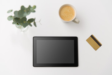 online shopping, sale and technology concept - tablet pc computer, credit card and cup of coffee on white background