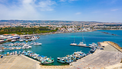 Fototapeta na wymiar Cyprus. Pathos. Panorama of the Mediterranean coast from a height. Boat Harbor. Pleasure and fishing boats at the pier. Boat trips in the Mediterranean sea.