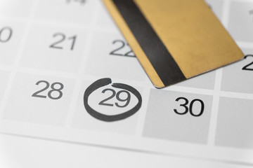 shopping, sale and marketing concept - close up of black friday date on calendar and credit card