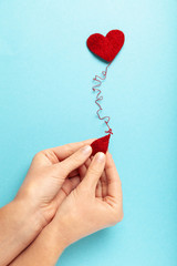 Blood donor. Hands with red heart and drop. Medical donation and blood transfusion.