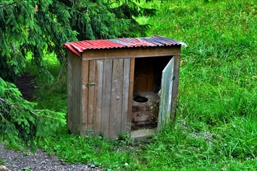 an old wooden toilet in the field