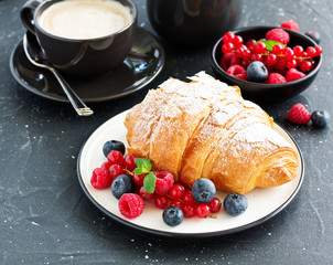 Delicious breakfast with fresh croissants and ripe berries