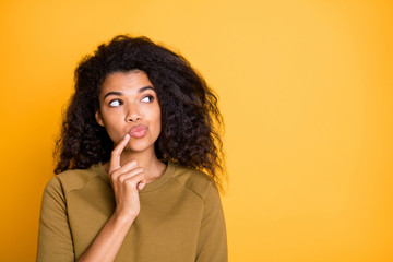 Closeup photo of pretty dark skin lady looking side empty space holding finger n chin deep thinking...