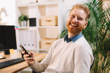 Businessman using phone in office