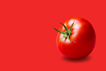 red tomato with a green stalk, on a red background, concept - obrazy, fototapety, plakaty