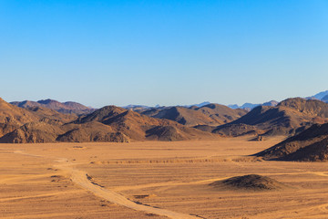Fototapeta na wymiar View of Arabian desert and mountain range Red Sea Hills in Egypt