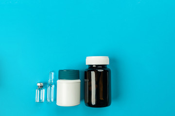 Two medicine bottles in white and brown on a blue background.Health concept. Healthy lifestyle concept. The concept of pharmacology. The concept of medicines. The concept of medicine.