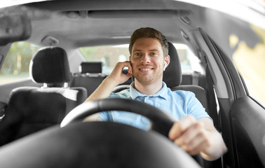 transport, vehicle and people concept - man or driver with wireless earphones or hands free device...