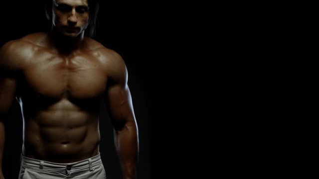 Fitness tanned guy showing muscles, close up, copy space