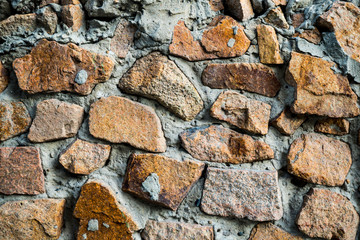 The texture of the old masonry. Background image of a stone-lined wall