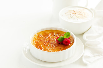 Creme brulee. dessert with caramel crust and berries.