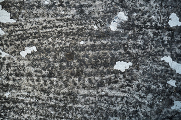 Texture of an old cracked concrete wall. Background image of a worn gray concrete surface