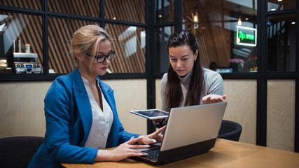 young HR woman interviews a candidate for a job. Business meeting two young women at work discussing the project
