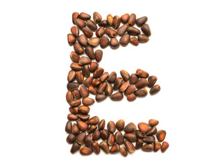 Isolated object: letter lined with ripe pine nuts