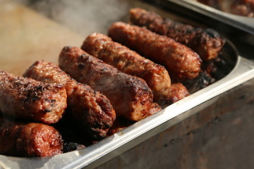 Mixed grilled meat platter. Assorted delicious grilled meat. The closeup of some meat skewers being grilled in a barbecue. grilled meat skewers, barbecue.