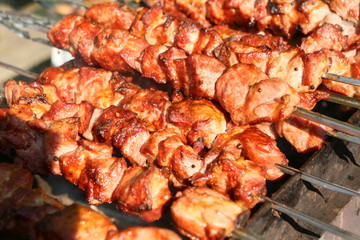 Mixed grilled meat platter. Assorted delicious grilled meat. The closeup of some meat skewers being grilled in a barbecue. grilled meat skewers, barbecue.