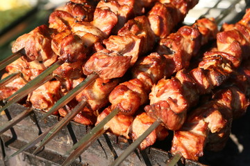 Mixed grilled meat platter. Assorted delicious grilled meat. The closeup of some meat skewers being grilled in a barbecue. grilled meat skewers, barbecue.