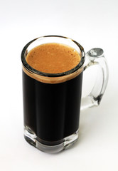 glass of dark beer on a white background, close-up