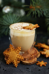 Gingerbread snowflake cookie, a cup of cappuccino for christmas.