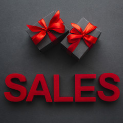Sales concept with presents on black background