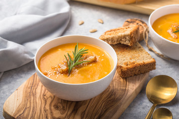 Homemade Autumn Butternut Squash pumpkin cream Soup with Bread and seeds. top view