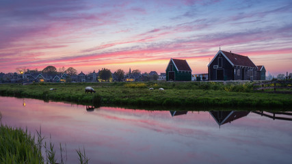 Panorama landscape  on water canal in village. Colorful spring sunset in Netherlands, Europe