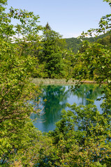 Picturesque landscapes of Plitvice Lakes with waterfalls, mountain rivers, forests and mountains