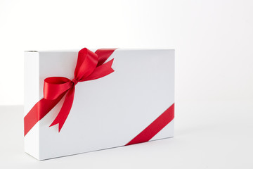 Red ribbon gift box on the white