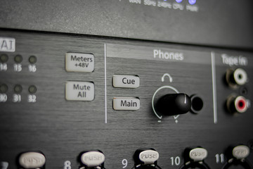 Control section for phones in an audio mixer, with cue and main buttons