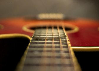 Fototapeta premium Alternative perspective of the acoustic guitar and its strings in the neck