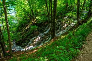 Picturesque landscapes of Plitvice Lakes with waterfalls, mountain rivers, forests and mountains